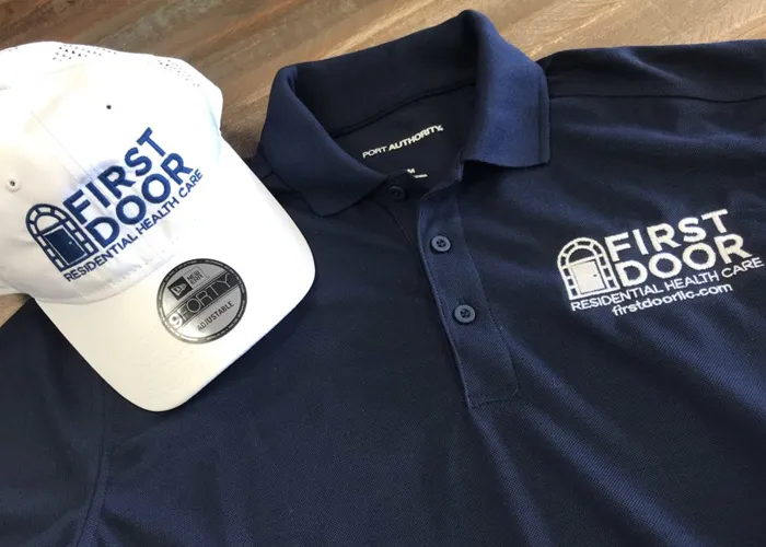 Close-up of professional logo embroidery on a work uniform shirt