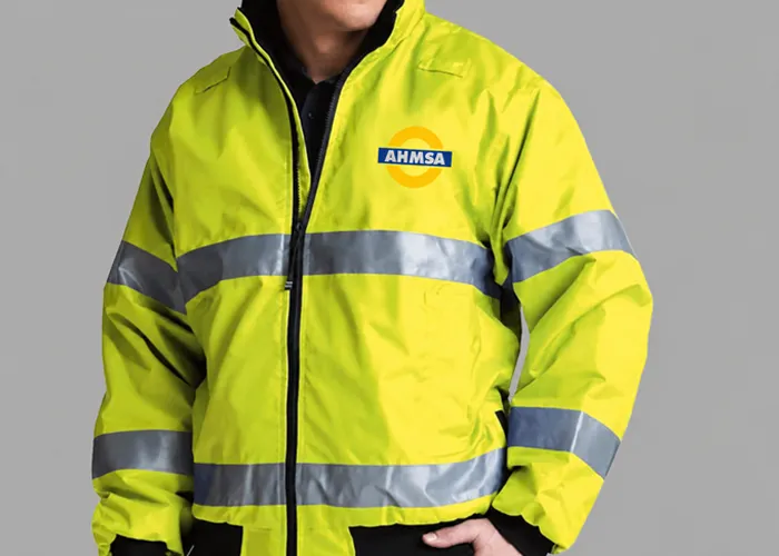 Worker wearing OSHA-compliant hi-vis safety gear and FR-rated workwear